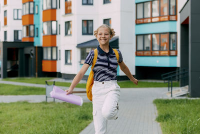 Portrait of young woman standing on field