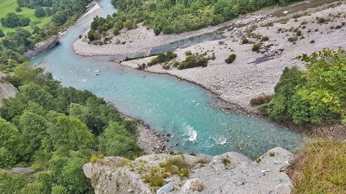 High angle view of river amidst trees against sky