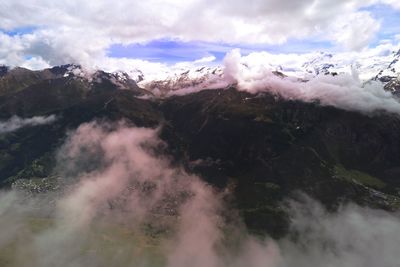 Scenic view of mountains against cloudy sky