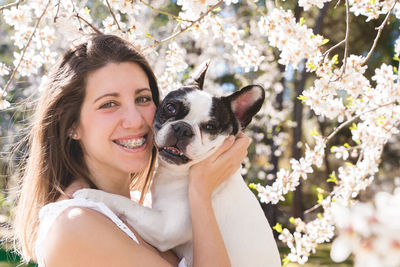 Portrait of young woman with dog