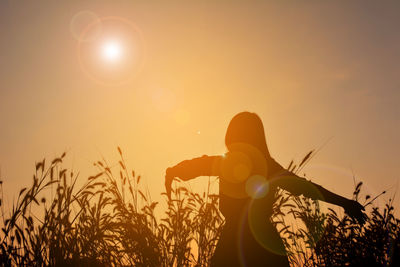Low angle view of silhouette woman during sunset