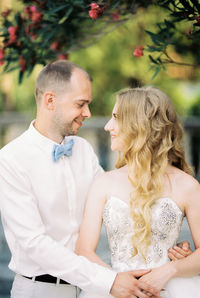 Portrait of smiling couple standing outdoors