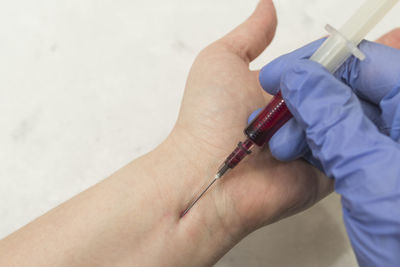 Cropped image of doctor injecting syringe
