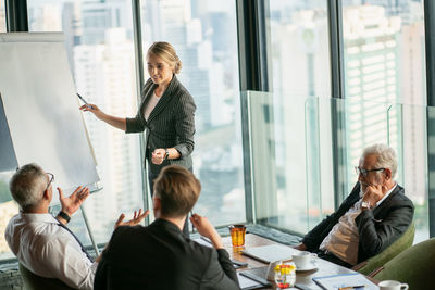 Friends looking away while sitting on table