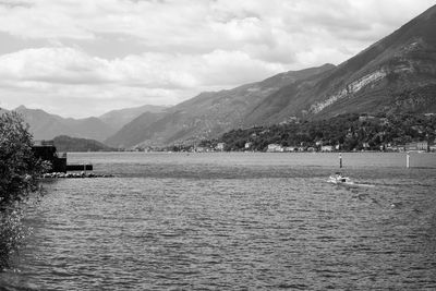 Scenic view of lake by mountains against sky