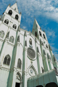 Low angle view of building against cloudy sky