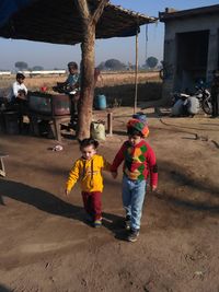 Children standing on sand