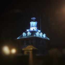 Low angle view of illuminated statue against sky at night