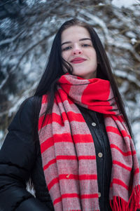 Portrait of smiling woman standing in snow