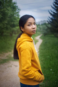 Side view of boy looking at camera