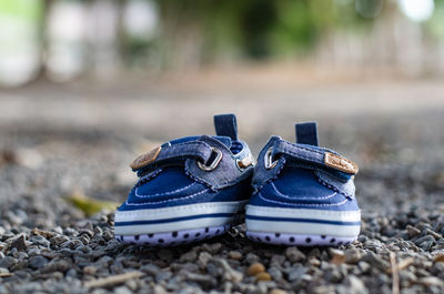 Close-up of shoes on stones