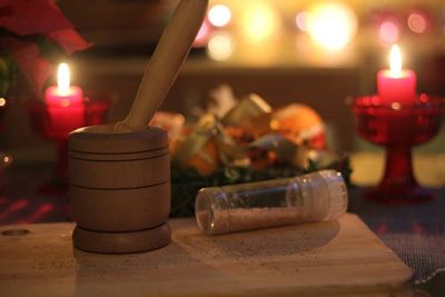 Close-up of lit candle in dark room