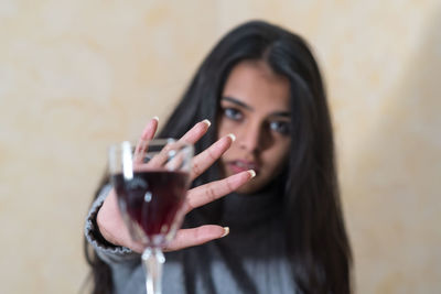 Portrait of young woman holding eyeglasses