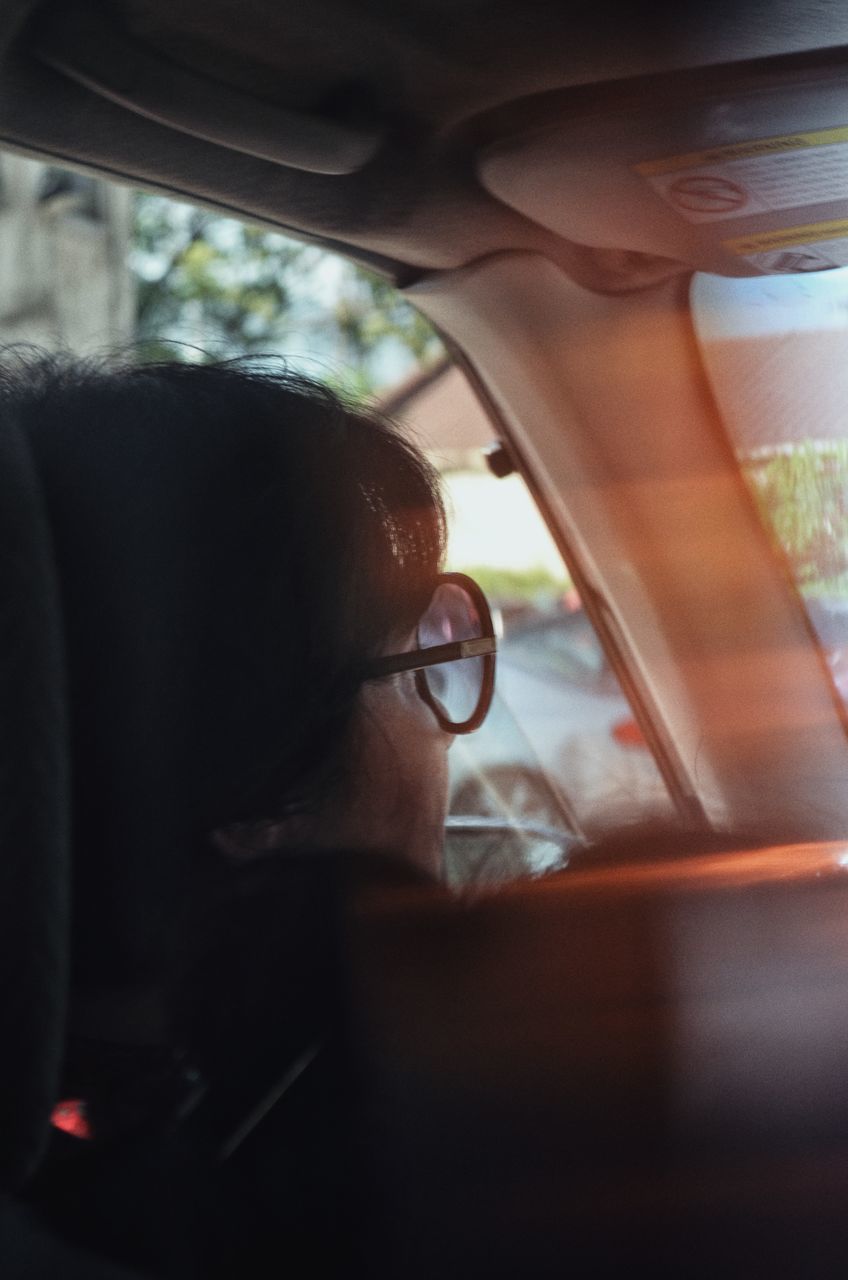 PORTRAIT OF WOMAN IN CAR