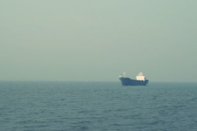 Boat sailing in sea against sky