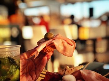 Close-up of hand holding ice cream in restaurant