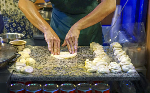 Midsection of person preparing food