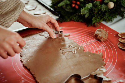 Process of woman making gingerbread cookies at home