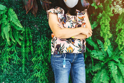 Midsection of woman holding plant