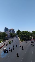 High angle view of vehicles on road along buildings