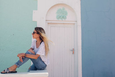 Woman sitting in front of building