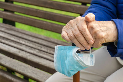 Midsection of man sitting on bench