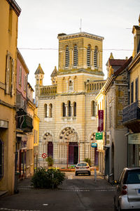 Street amidst buildings in city against sky