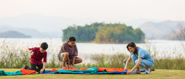 Rear view of people playing in lake