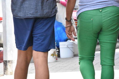 Midsection of couple standing outdoors