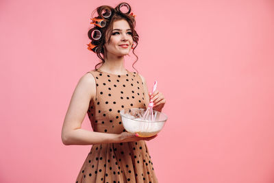 Portrait of woman with pink hair against gray background