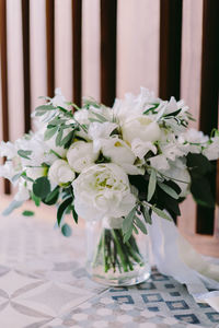 Close-up of white roses in vase on table