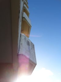 Low angle view of building against sky on sunny day