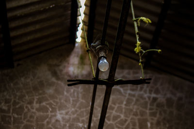 High angle view of cross hanging on wall at home