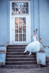 White horse standing on staircase of building