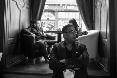 Man looking away while sitting at restaurant