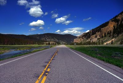 Empty road with mountains in background