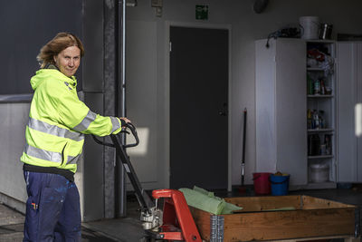 Woman pushing pallet truck