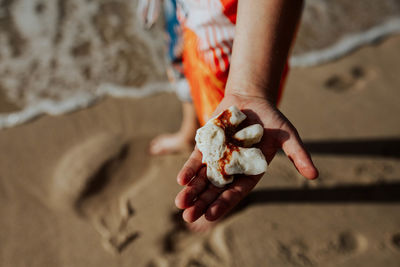 Close-up of hand holding ice cream