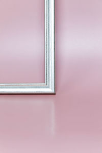 Frame on a pink background.  photograph of a window.