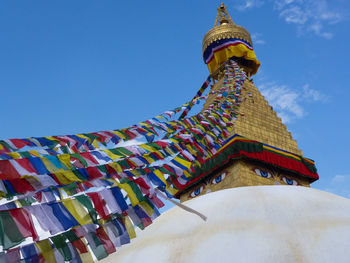 Low angle view of traditional building against blue sky