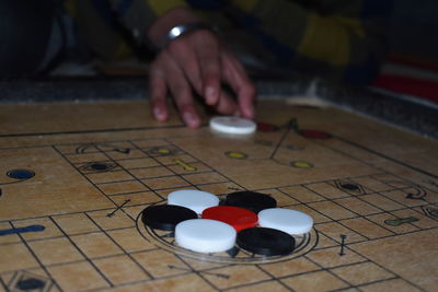 Close-up of person playing piano on table