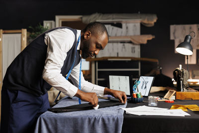 Side view of senior man working at home