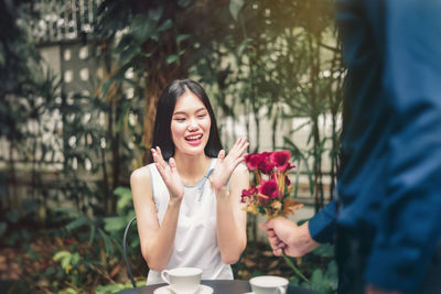 Man giving flowers to woman