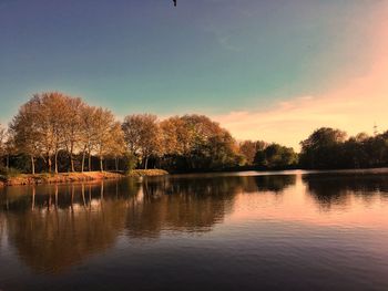 Scenic view of lake against sky at sunset