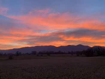 Scenic view of field against sky during sunset