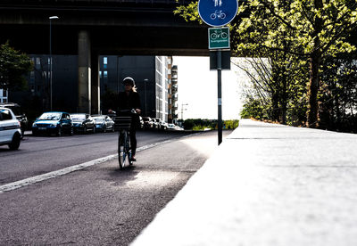 Man riding bicycle on road