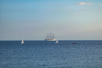 Sailboat sailing on sea against sky
