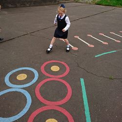 Portrait of young woman playing on street