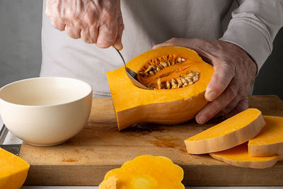 Midsection of man holding pumpkin