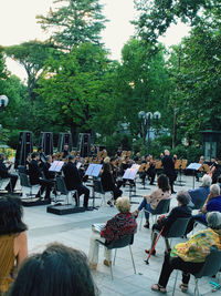 Group of people sitting on table in city